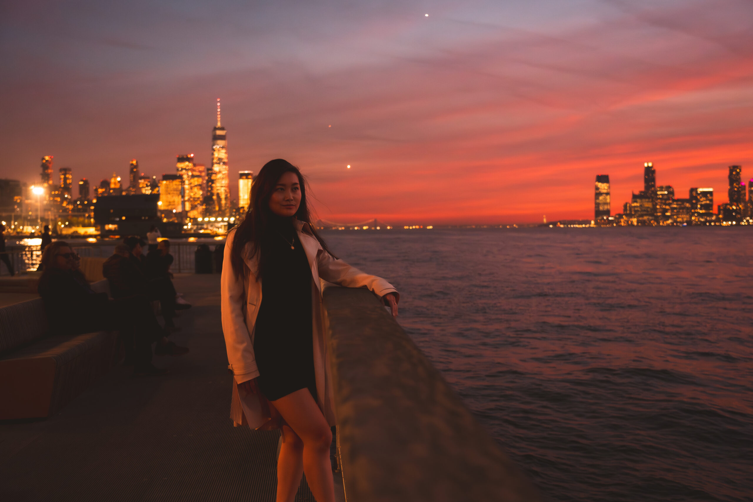 jessica hwang gazing over the hudson river with the nyc skyline behind her